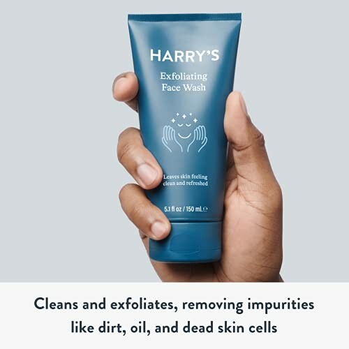 Hand holding Harry's Exfoliating Face Wash tube.