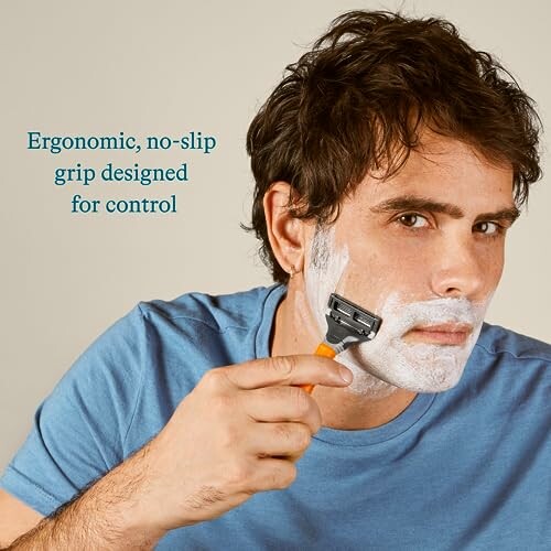 Man shaving with razor and foam