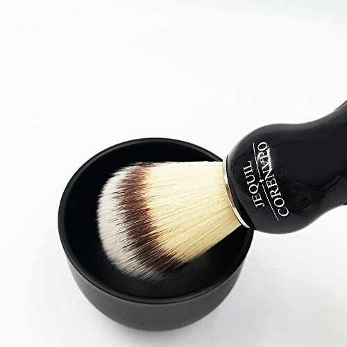 Shaving brush with black handle and bowl.
