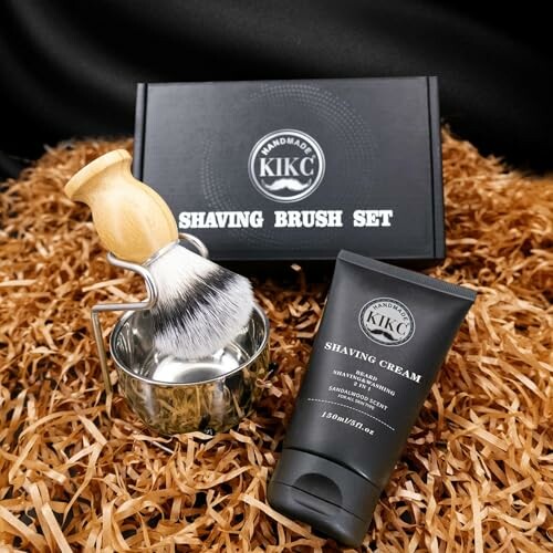 Shaving brush set with cream and metal bowl on straw.